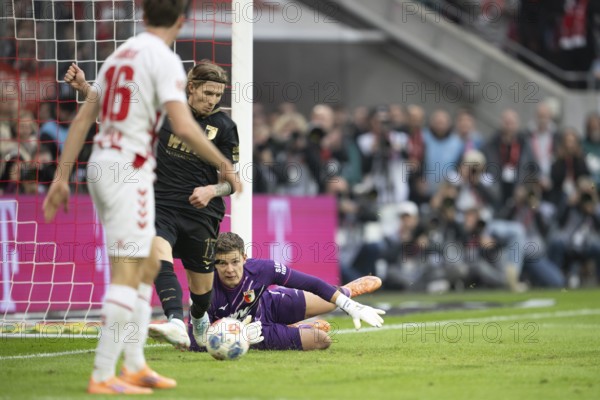 Kristijan Jakic (FC Augsburg, midfield, #17), Finn Dahmen (FC Augsburg, goalkeeper, #1), COLOGNE, Germany - OCTOBER 18: During the Bundesliga match between FC Cologne vs. FC Augsburg at Rheinenergie-Stadion on matchday 8 of the 1st Bundesliga on October 18, 2025 in Cologne, Germany. DFL REGULATIONS PROHIBIT ANY USE OF PHOTOGRAPHS AS IMAGE SEQUENCES AND/OR QUASI-VIDEO, Rheinenergie-Stadion, Cologne, North Rhine-Westphalia, Germany