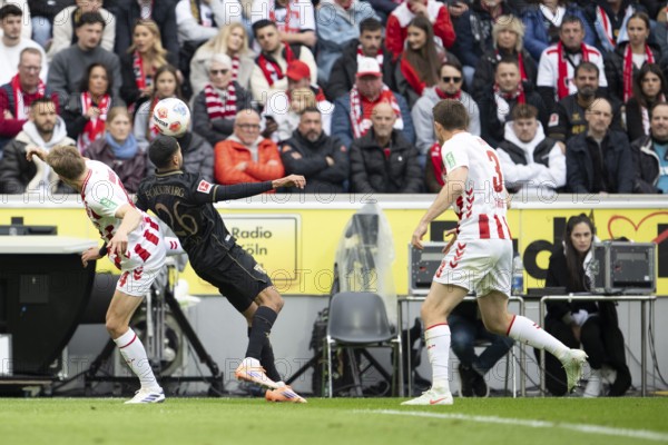 Timo Hübers (1.FC Cologne, defense, #4), Elias Saad (FC Augsburg, attack, #26), COLOGNE, Germany - OCTOBER 18: during the Bundesliga match between 1. FC Cologne vs. FC Augsburg at Rheinenergie-Stadion on matchday 8 of the 1. Bundesliga on October 18, 2025 in Cologne, Germany. DFL REGULATIONS PROHIBIT ANY USE OF PHOTOGRAPHS AS IMAGE SEQUENCES AND/OR QUASI-VIDEO, Rheinenergie-Stadion, Cologne, North Rhine-Westphalia, Germany