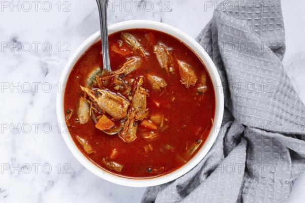 French shrimp bisque soup, on a marble table, close-up, no people