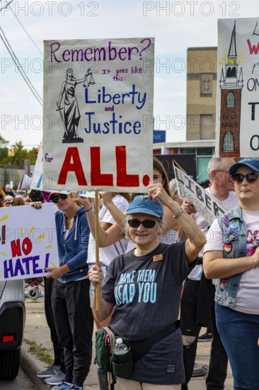 Detroit, Michigan USA - 18 October 2025 - Protesters from Detroit and Grosse Pointe gathered on the border between their cities for a 'No Kings' rally, protesting President Trump's actions against immigrants and against democratic institutions