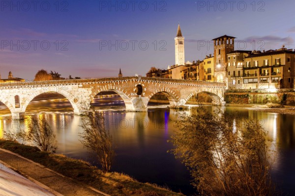 Ponte Pietra (Stone Bridge) over Adige River at evening, built by the Romans in 100 BC. Verona, Province of Verona, Italy. 09.12.2012