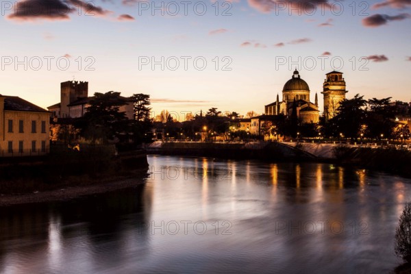Adige River at evening and San Giorgio in Braida Church (Chiesa di San Giorgio in Braida) in the bakground. Verona, Province of Verona, Italy. 09.12.2012