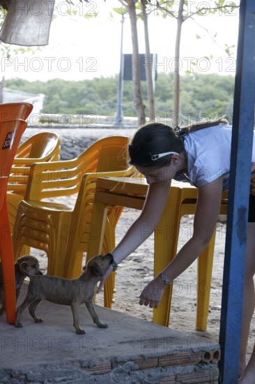 Woman Playing with Dog, Alcântara, Maranhão, Brazil