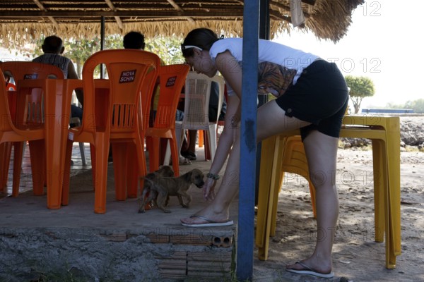 Woman Playing with Dog, Alcântara, Maranhão, Brazil