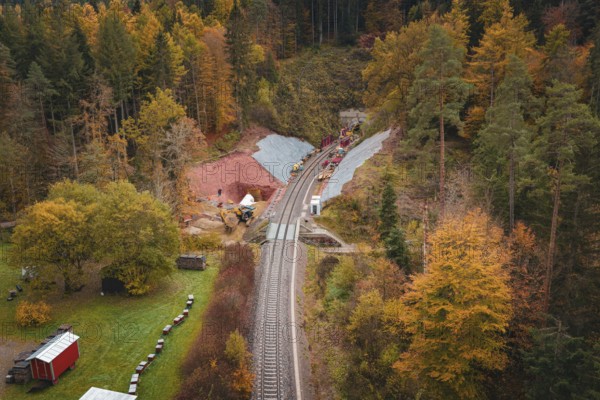 Railway line with tunnel construction, surrounded by autumnal forests and landscape panorama, Hermann-Hesse-Bahn construction site, Calw, Germany