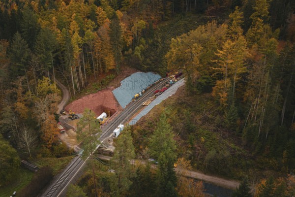 Railway tunnel construction in an autumn forest environment seen from the air, Hermann-Hesse-Bahn construction site, Calw, Germany
