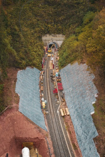 Rail construction in the forest with tunnel opening, surrounded by autumn leaves, Hermann-Hesse-Bahn construction site, Calw, Germany