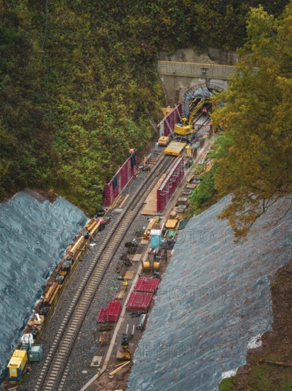 View of construction work on tracks and tunnels, surrounded by autumnal forest, Hermann-Hesse-Bahn construction site, Calw, Germany