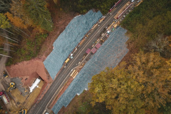 Railway line from above, surrounded by autumn colors, with construction work on the tracks, Hermann-Hesse-Bahn construction site, Calw, Germany