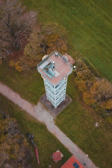 An observation tower in the middle of a rural landscape with fields and buildings, surrounded by autumn colors, Dürrenmettstetten observation tower, Germany