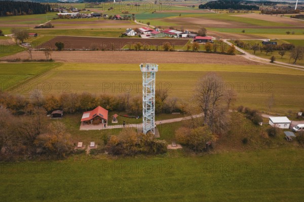 View of an observation tower in a rural area with fields and a village in the background, Dürrenmettstetten observation tower, Germany