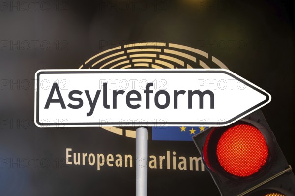 (photo montage) Directional arrow with the inscription ASYLUM REFORM in front of the European Union lettering