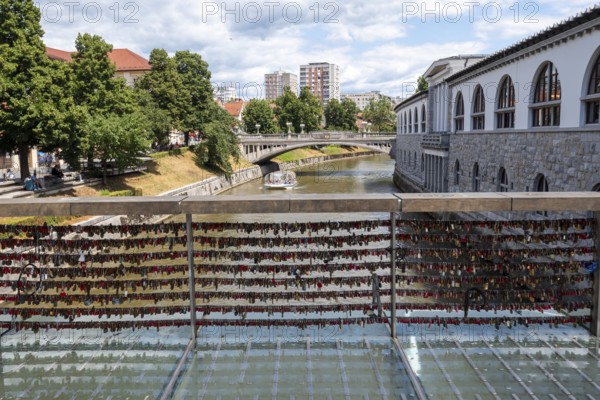 Love locks hang in several rows on the railing of the Mesarski Most (butcher's bridge) over the Ljubljanica in Ljubljana, Slovenia
