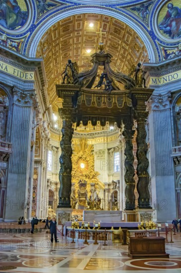 Canopy canopy ciborium by Gian Giovanni Lorenzo Bernini over Peter's tomb and papal altar in St. Peter's Basilica, in the background main apse of St. Peter's Basilica with stylized larger-than-life bronze throne reliquary for wooden chair decorated with ivory tablets Catheda Petri alleged chair of Simon Peter, Basilica of St. Peter, Vatican, Rome, Lazio, Italy