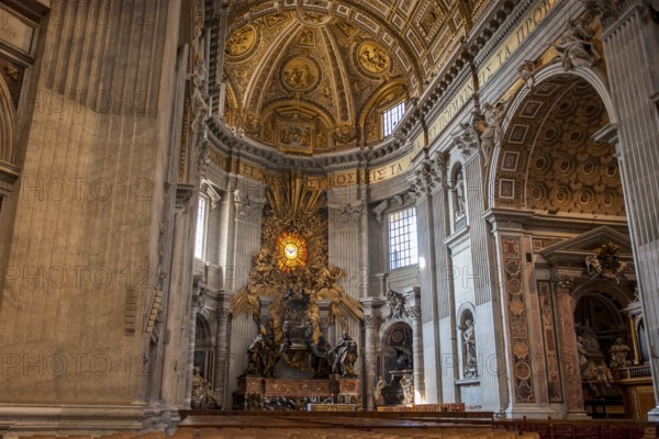 View of in the main apse of St. Peter's Basilica with stylized larger-than-life bronze throne reliquary for wooden chair decorated with ivory plates Catheda Petri alleged chair of Simon Peter, Basilica of St. Peter, Vatican, Rome, Lazio, Italy