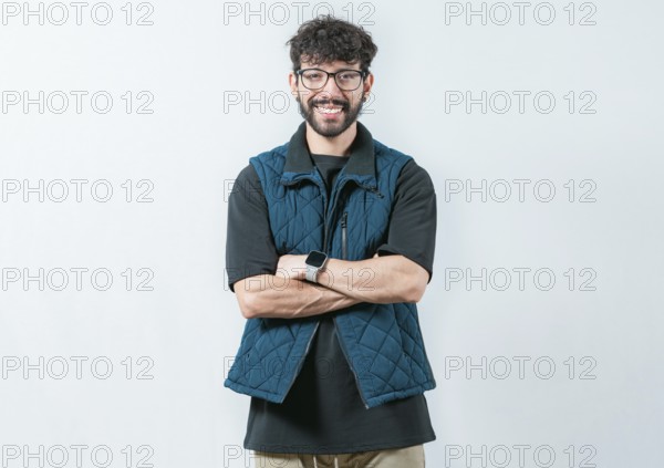 Portrait of cool and handsome casual man with glasses and crossed arms. Smiling and handsome guy with glasses holding arms crossed isolated
