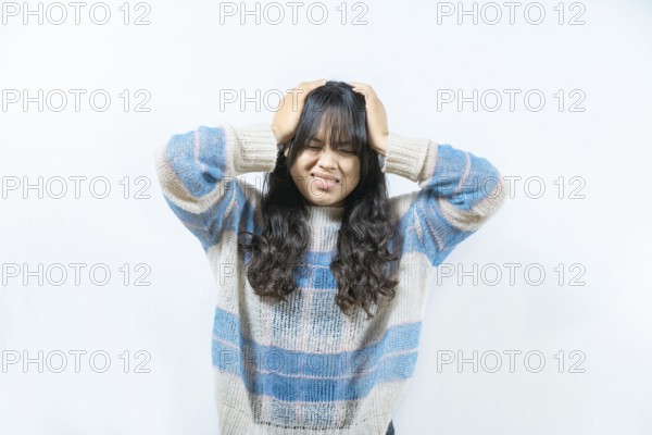 Stressed woman holding his head isolated. Painful girl with migraine holding his head isolated