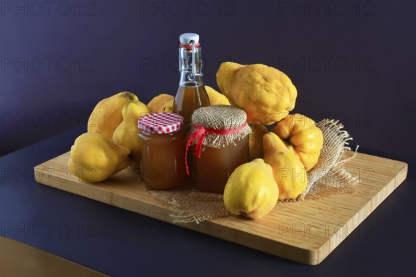 Still life with quinces, homemade quince jelly and quince liqueur, autumn, Germany