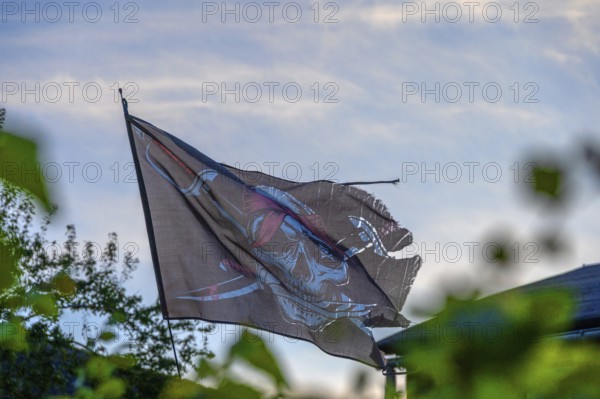 Pirate flag in a garden, Ahrenshoop, Darß, Mecklenburg-Western Pomerania, Germany