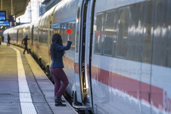 ICE train ready for departure, train staff waiting for the signal to continue, at Essen main station, on the platform, North Rhine-Westphalia, Germany