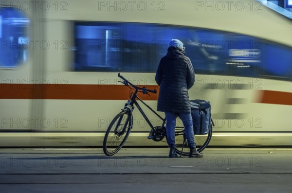 Cyclists waiting for the train, in Essen main station, on the platform, North Rhine-Westphalia, Germany