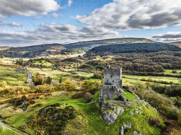 Autumn colours over Castell Dolwyddelan and Eryri Mountains from a drone, Snowdonia, Conwy County Borough, Wales, England, United Kingdom