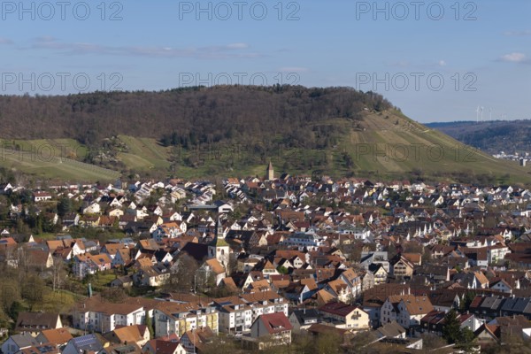 City view with hills in the background, lots of red house roofs and green surroundings under blue sky, Korb im Rems Valley, Baden-Württemberg, Germany