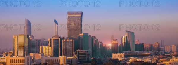 UAE, United Arab Emirates, Abu Dhabi downtown panorama and financial center skyline at sunset