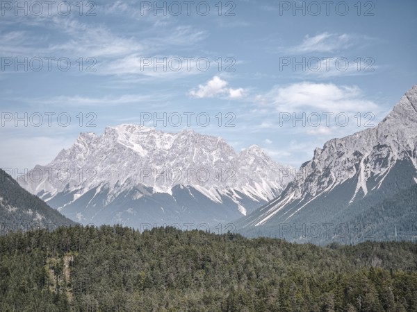 View of the Zugspitze massif in the Wetterstein Mountains of the Alps in Germany and Austria from southwestern direction from Blindsee in Biberwier, Tyrol, Austria