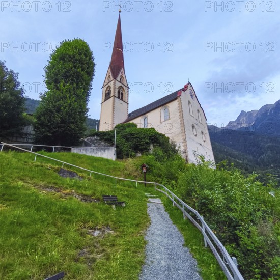 Late Gothic Catholic parish church of Saints George and Nicholas from around 1500 with churchyard, in Oetz im Ötztal, Tyrol, Austria