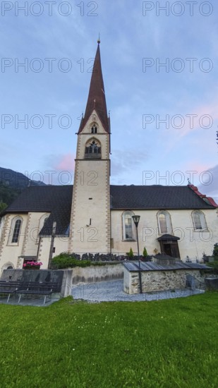 Late Gothic Catholic parish church of Saints George and Nicholas from around 1500 with churchyard, in Oetz im Ötztal, Tyrol, Austria