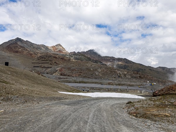 Alpine mountain landscape with covered snowfields at the valley station of the Tiefenbach cable car in the area of the Tiefenbach Glacier near Sölden, Ötztal, Tyrol, Austria