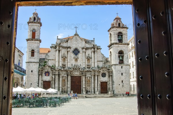 View from through portal Entrance of Museo de Arte Colonial Casa de Don Luis Chacón across Plaza de la Catedral Cathedral Square of the Cathedral of the Virgin Mary of the Immaculate Conception Catedral de la Virgen María de la Concepción Inmaculada de La Habana in Old Havana, La Habana Vieja, Havana, Cuba