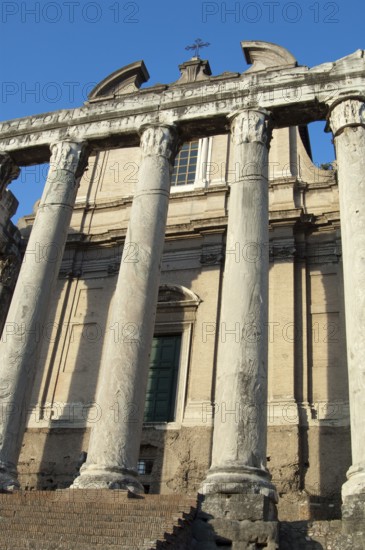 View from today's ground level of the Roman Forum as in Augustan period by Emperor Augustus of historical columns preserved from ancient Roman times of temples of Antoninus Pius and Faustina dating from 141 AD in the 11th century into Chiesa di San Lorenzo in Miranda, Roman Forum, Lazio, Italy