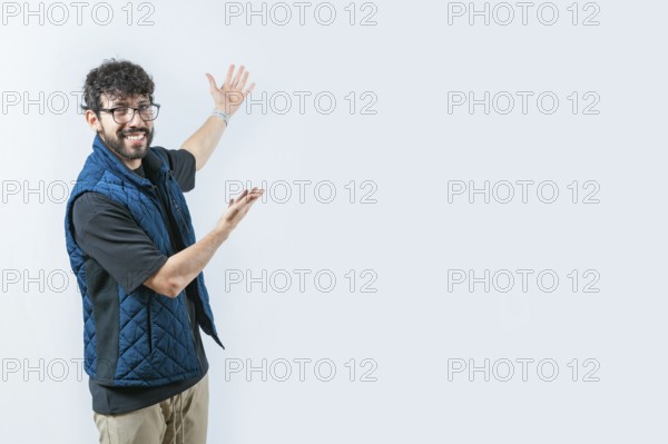 Handsome guy welcoming you on isolated bakground. Smiling Handsome Man Presenting something isolated