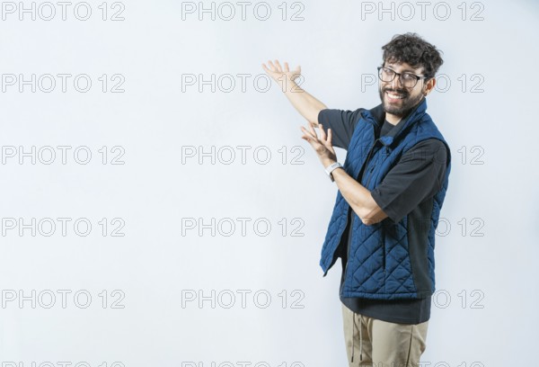 Smiling Handsome Man Presenting something isolated. Handsome guy welcoming you on isolated bakground