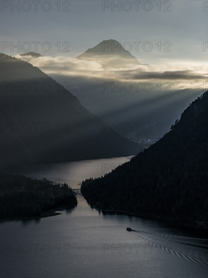 Mountain lake, mountains, sunrays, back light, fog, boat, sightseeing boat, evening light, Plansee, Tyrol, Austria