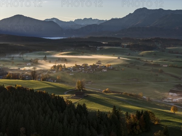 Village, mountains, sunny, morning light, autumn, autumn color, fog, aerial view, back light, Riegsee, Upper Bavaria, Bavaria, Germany