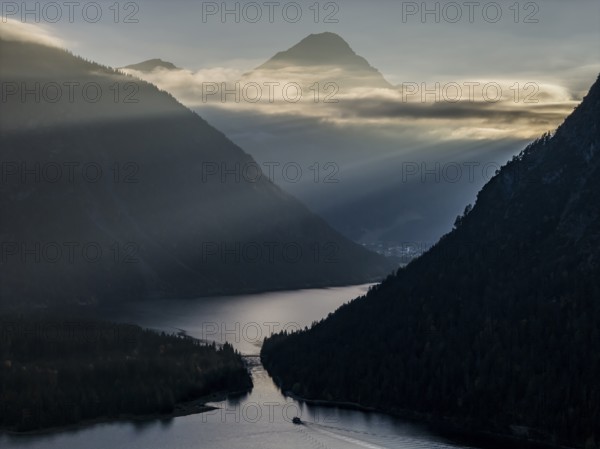 Mountain lake, mountains, sunrays, back light, fog, boat, sightseeing boat, evening light, Plansee, Tyrol, Austria