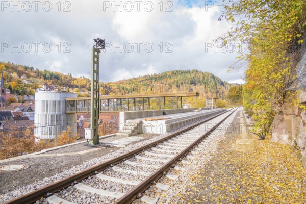 Railway track with autumn leaves, modern architecture and mountainous background, ZOB Calw, Hermann Hessebahn, Calw, Germany