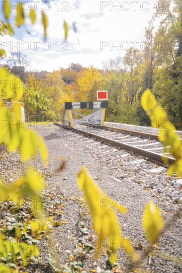 End of a railroad track with a barrier, surrounded by autumn trees, ZOB Calw, Hermann Hessebahn, Calw, Germany