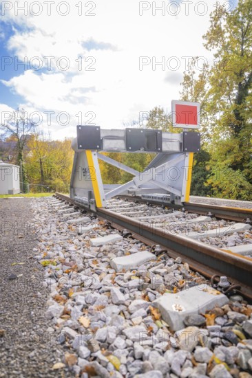 Rail end with barrier against autumn background and blue sky, ZOB Calw, Hermann Hessebahn, Calw, Germany