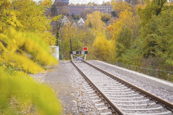 Railway barrier at the end of the tracks surrounded by autumn nature, ZOB Calw, Hermann Hessebahn, Calw, Germany