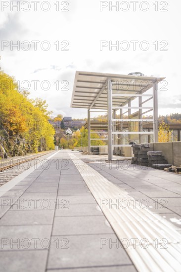 Abandoned platform in autumn with yellow trees and modern construction, ZOB Calw, Hermann Hessebahn, Calw, Germany