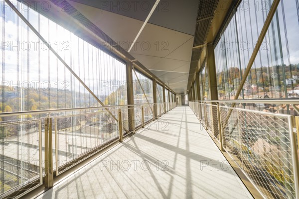 Modern footbridge with view of sunny landscape and metal grids, ZOB Calw, Hermann Hessebahn, Calw, Germany