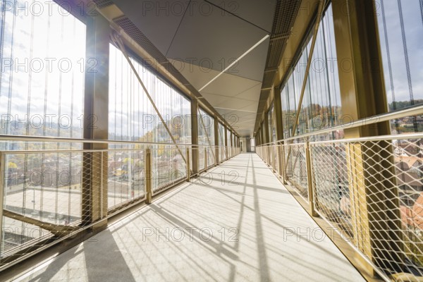 Long, modern footbridge with shadows cast by metal grids, ZOB Calw, Hermann Hessebahn, Calw, Germany