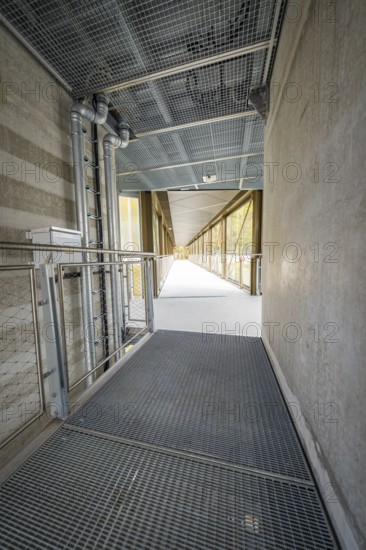 Industrial-style corridor with mesh floor and pipes, ZOB Calw, Hermann Hessebahn, Calw, Germany