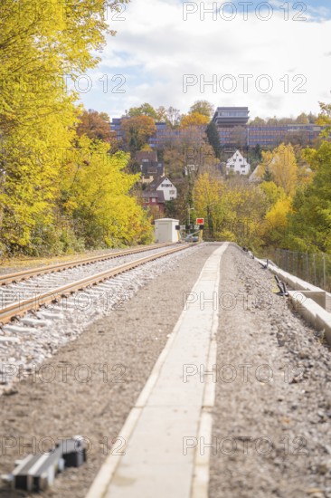 Landscape with railroad tracks, autumn leaves and houses on a hill in sunshine, ZOB Calw, Hermann Hessebahn, Calw, Germany