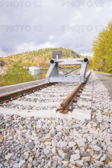 Railway line with rail stopper in autumn landscape under cloudy sky, ZOB Calw, Hermann Hessebahn, Calw, Germany