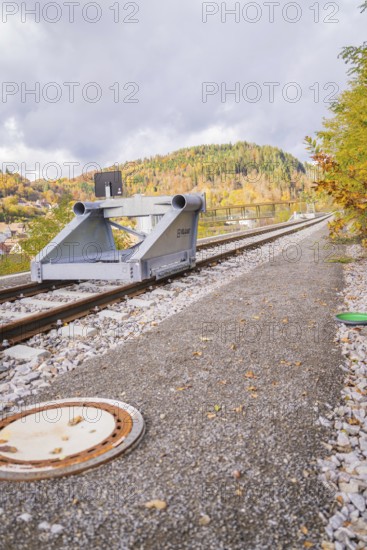 End of train tracks with autumnal mountain landscape and cloudy sky, ZOB Calw, Hermann Hessebahn, Calw, Germany
